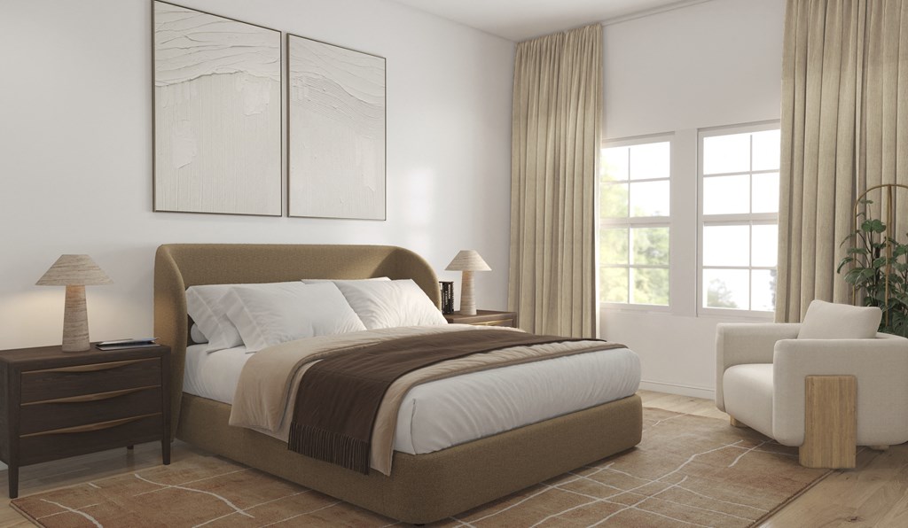 A bedroom with a large bed, a nightstand, a chair, and a plant.