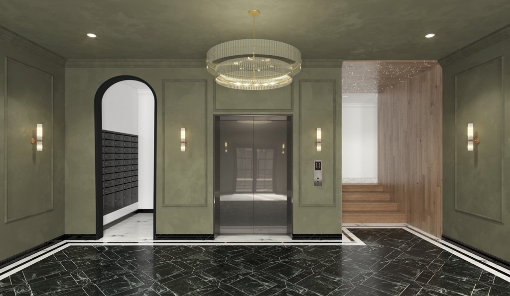 A hallway with a black and white marble floor and green walls.