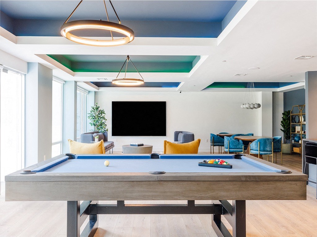 a pool table in a living room with a tv