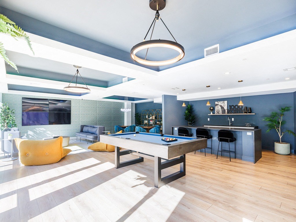 a game room with a pool table and a bar