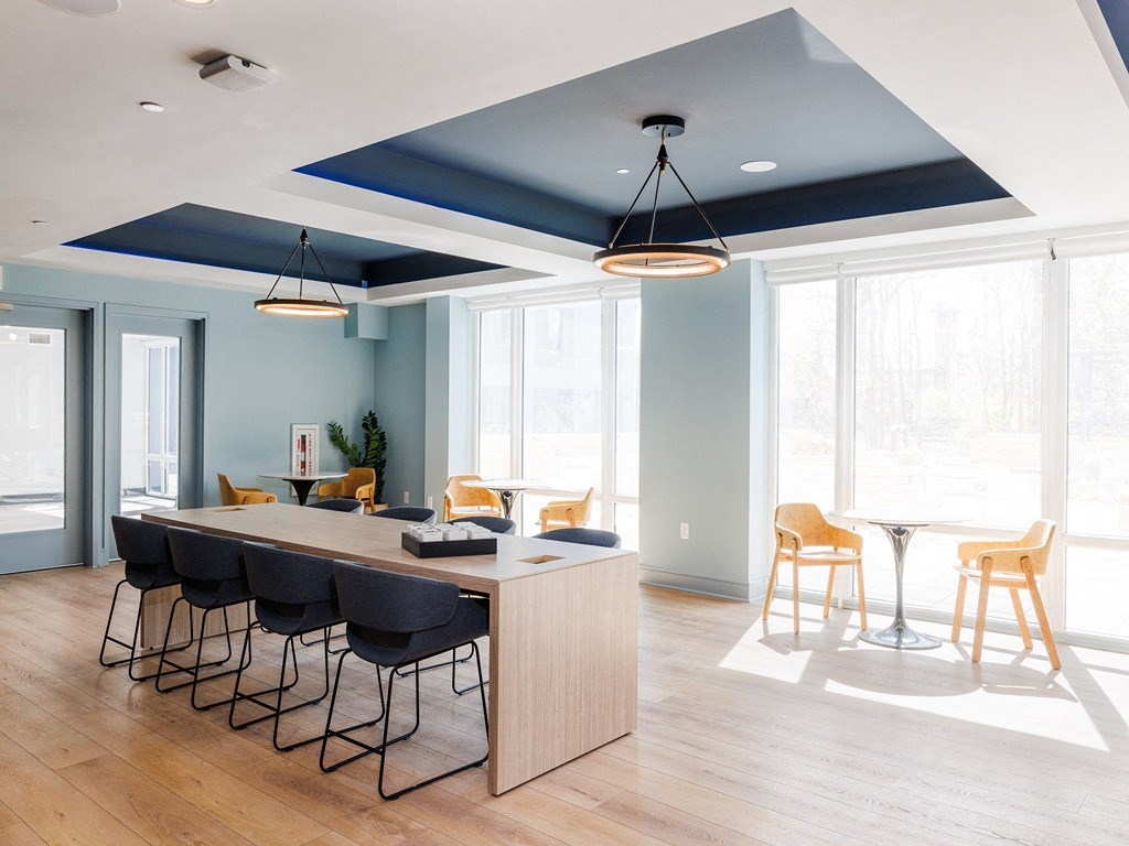 a conference room with a long table and chairs and blue ceilings