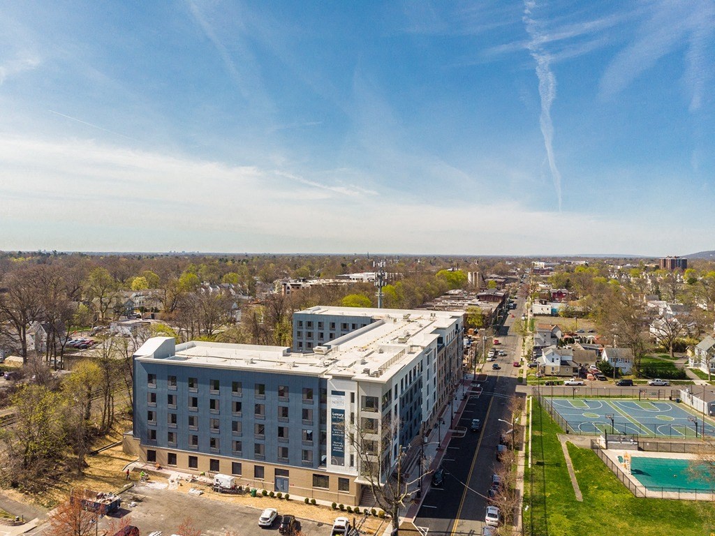an aerial view of a large building with a white roof