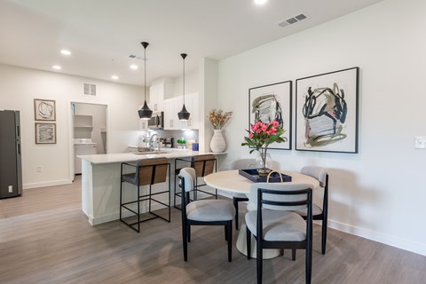 A dining room with a table set for four.