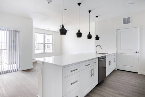 A kitchen with white cabinets and a white counter top.