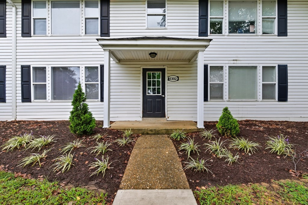 A white house with a black door and windows.