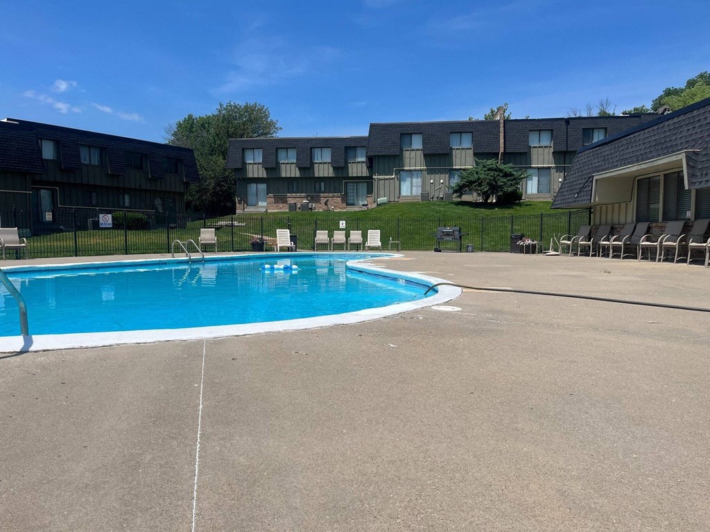 a swimming pool in front of an apartment building