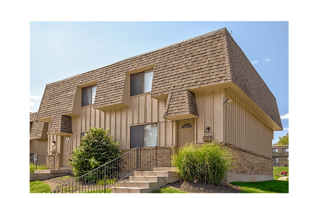 the front of a house with stairs and a yard