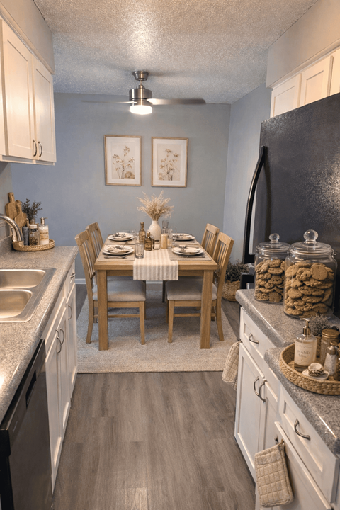 A kitchen with a table set for a meal.