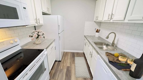 a kitchen with a sink and a refrigerator