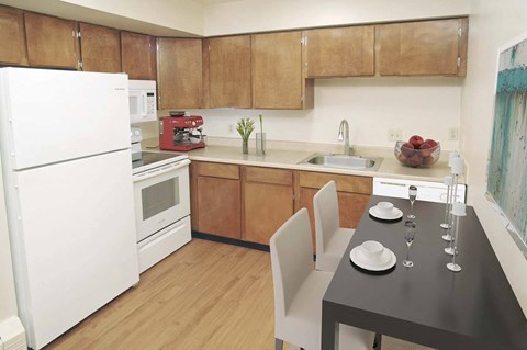 a kitchen and dining area with a table and chairs