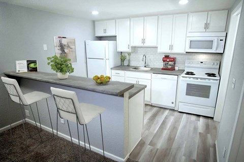 a kitchen with white appliances and white cabinets