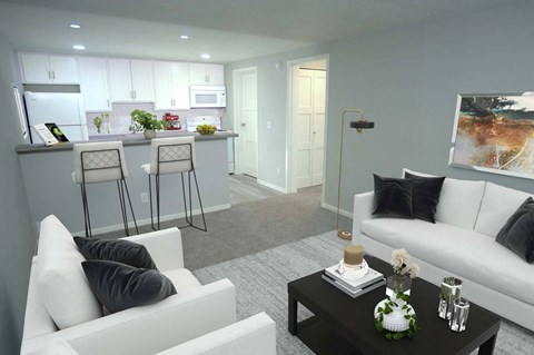 a living room and kitchen with white couches and a table