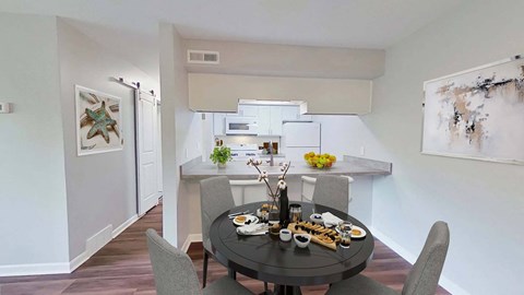 a kitchen and dining room with a table and chairs