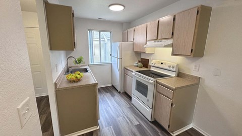 a kitchen with white appliances and wooden cabinets