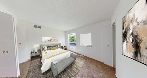 A bedroom with a large bed and a painting on the wall.