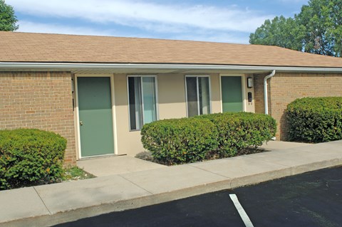 A building with a green door and a grey door.