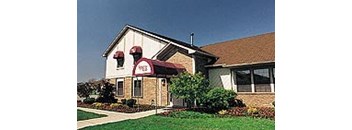 a large house with a red awning on the front