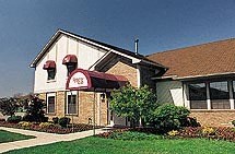 a large house with a red awning on the front