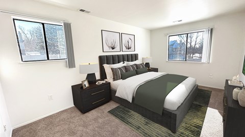 A bedroom with a large bed and two windows.