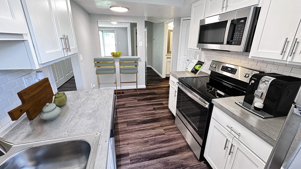 a kitchen with stainless steel appliances and white cabinets