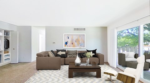 A living room with a brown couch and a coffee table.