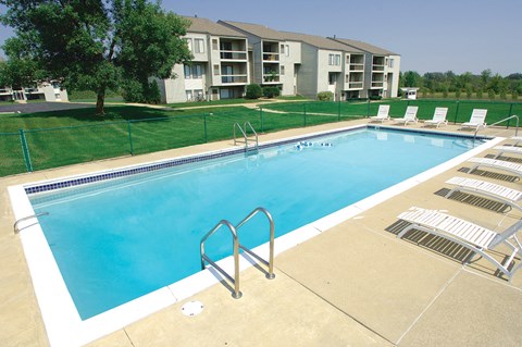 A swimming pool with a metal ladder in the middle of it.