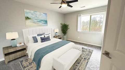 A bedroom with a large bed and a ceiling fan.