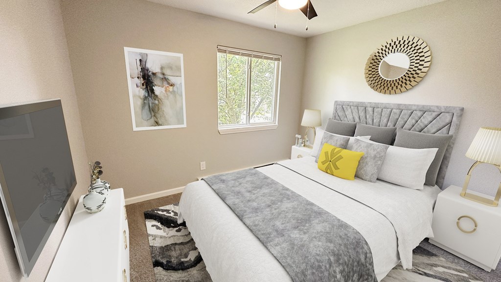 A bedroom with a bed, a television, and a rug.