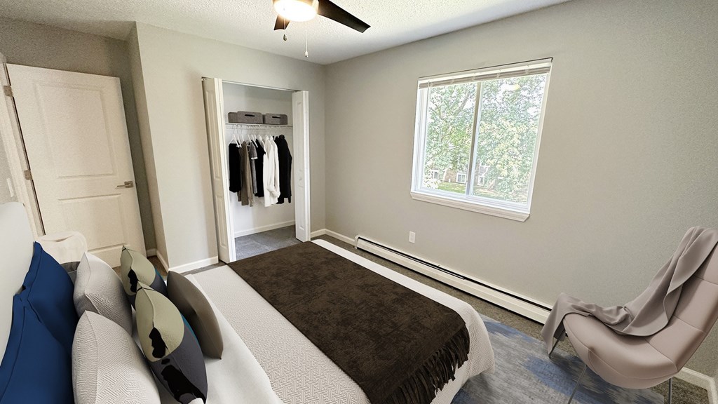 A bedroom with a bed, chair, and wardrobe.
