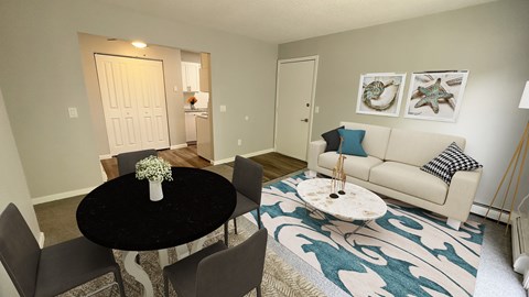 A living room with a black table and a white couch.