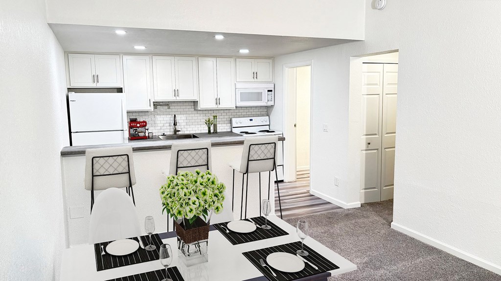 A kitchen with white cabinets and a black and white rug.