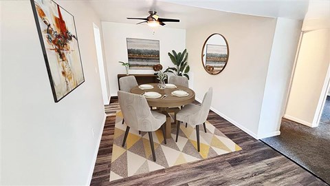 A dining room with a table and chairs.
