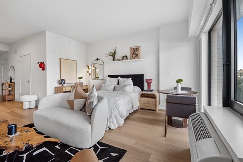 A modern bedroom with a large bed and a chair.