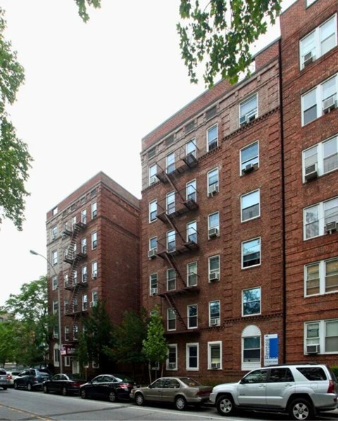 A red brick building with a blue sign on the side.