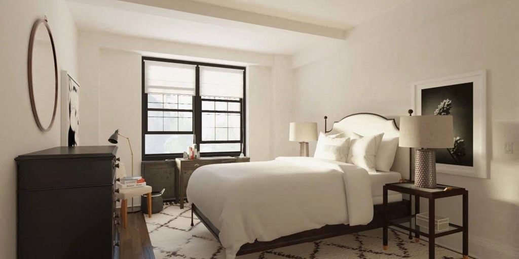 A bedroom with a large bed, a dresser, and a window with blinds.at London Terrace Gardens, New York