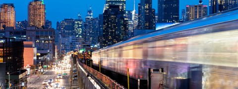 A train is passing through a city at night.