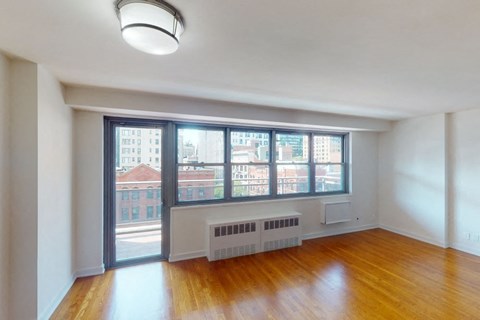 A room with a window overlooking a cityscape.