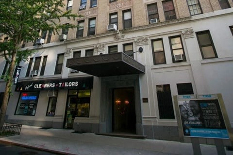 A building with a sign that says "CLE INERS T'ILORS" on it.