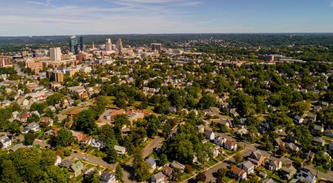A cityscape with a mix of residential and commercial buildings.