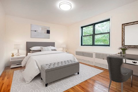 A bedroom with a large bed and a chair.