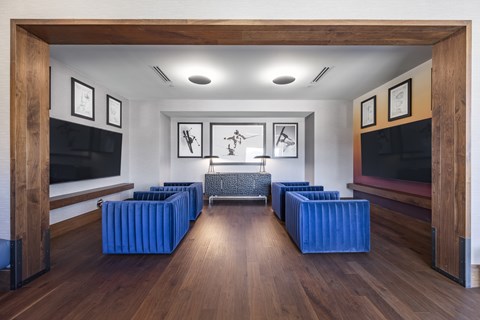 A living room with a blue couch and a television.