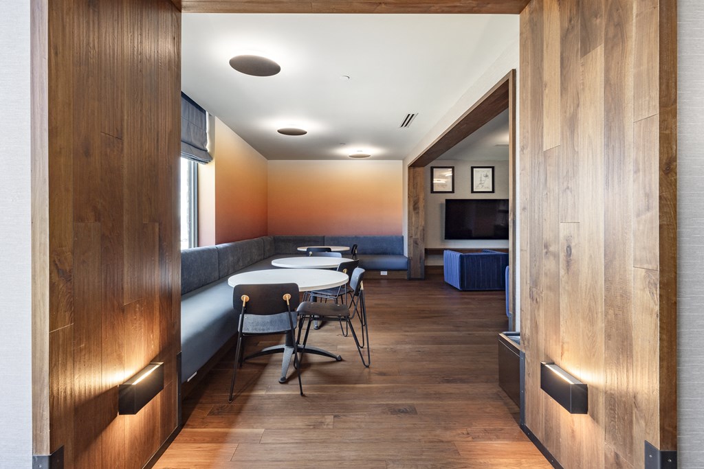 a dining room with a table and chairs and a television