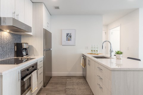 a kitchen with white cabinets and a counter top