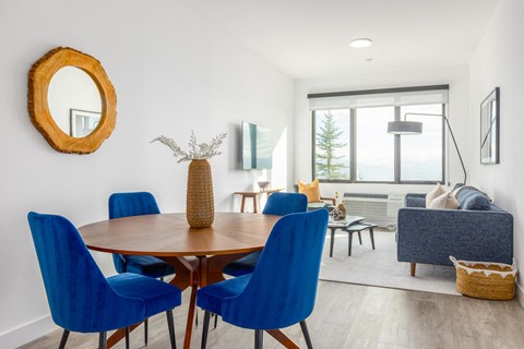 a dining room with blue chairs and a wooden table