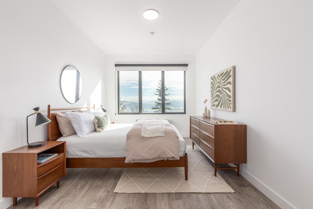 a bedroom with a bed and a window