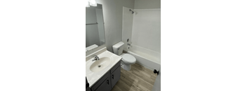 a bathroom with a sink toilet and a bath tub