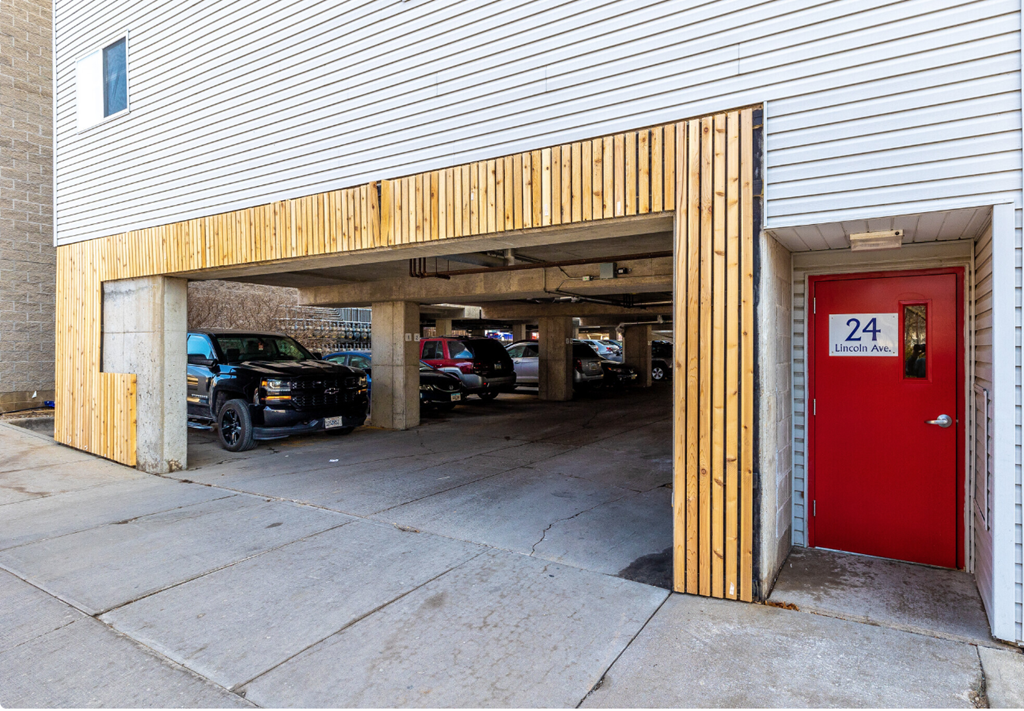 a red door to a parking garage with cars in it
