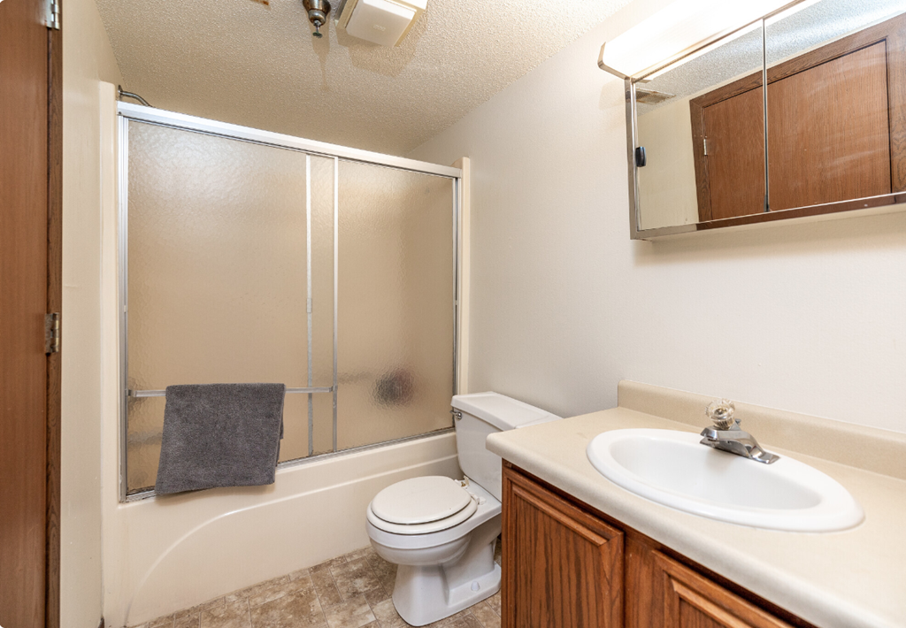 an updated bathroom with a shower toilet and sink
