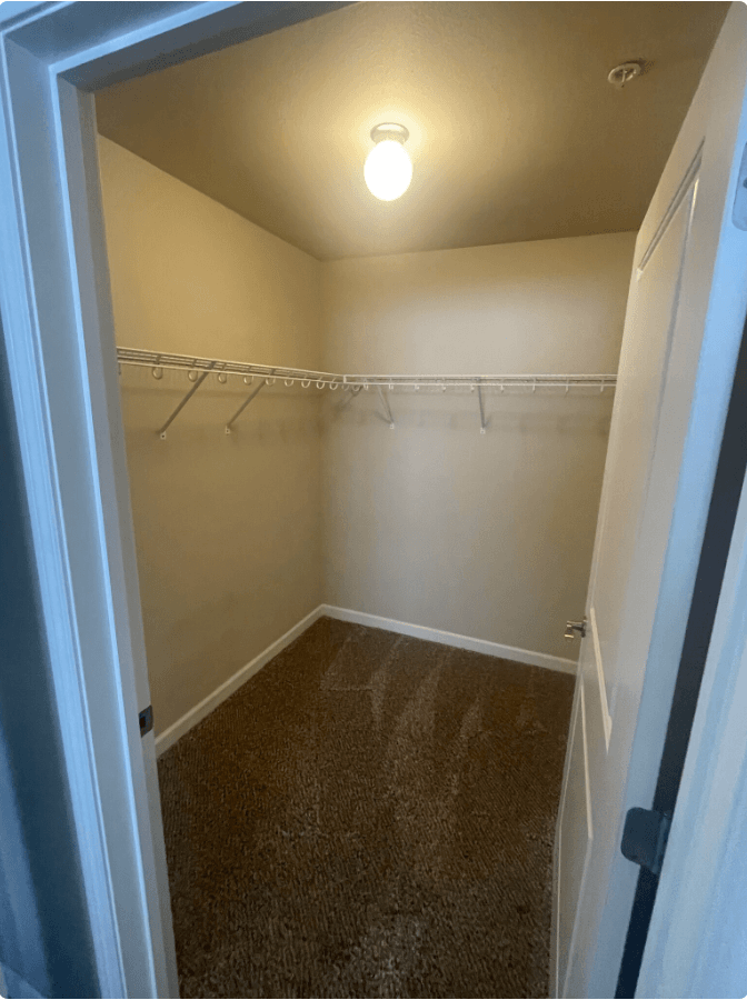 a room with a closet and a clothes rack