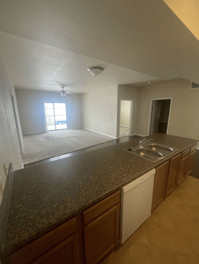an empty kitchen and living room in a house